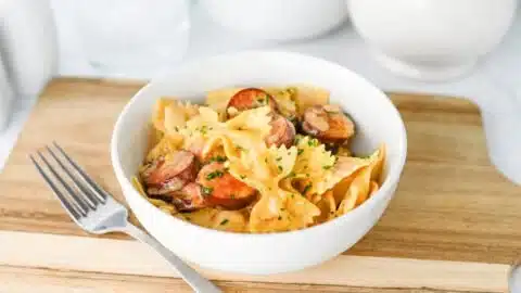 Serving of Easy Creamy Cajun Sausage Bowtie Pasta with herbs